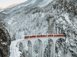 Bernina Express crossing the snow-covered Landwasser Viaduct in Graubünden in winter