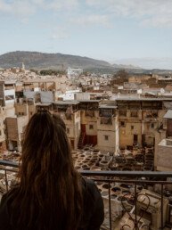 A woman looking down from a gallery on the tannery of Sidi Moussa in Fes