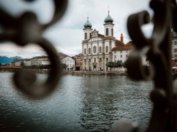 photograph of the jesuit church in lucerne from a bridge