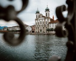 photograph of the jesuit church in lucerne from a bridge