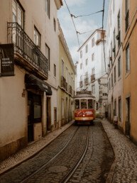 tram 28 in lisbon between houses