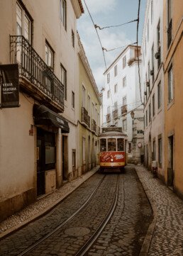 tram 28 in lisbon between houses